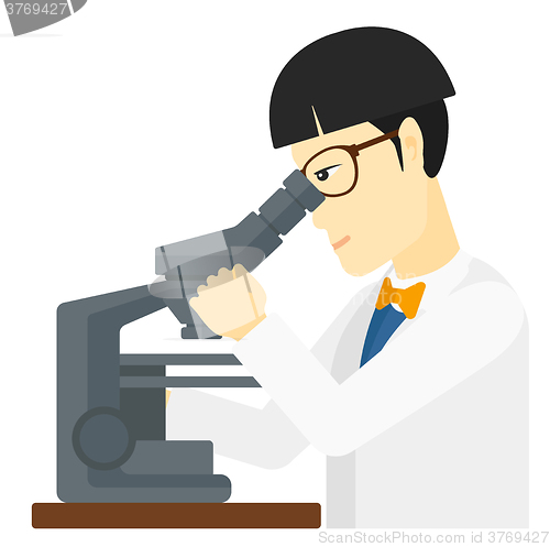 Image of Laboratory assistant with microscope.