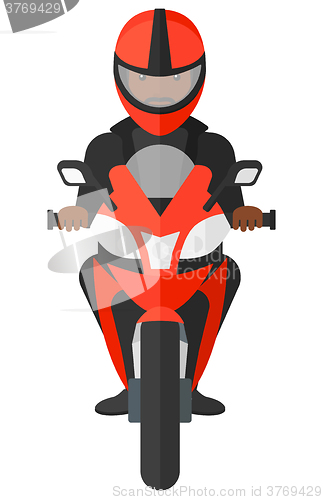 Image of Man riding motorcycle.