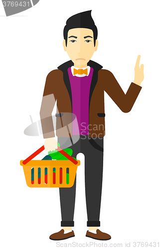 Image of Man holding supermarket basket.