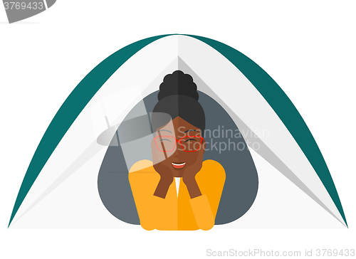 Image of Woman lying in tent.