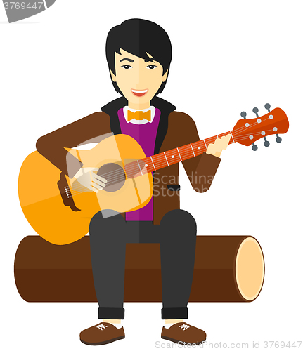 Image of Man playing guitar.