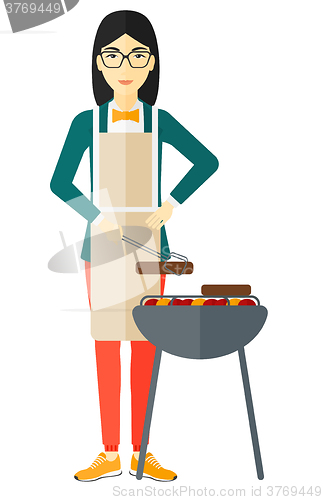 Image of Woman preparing barbecue.