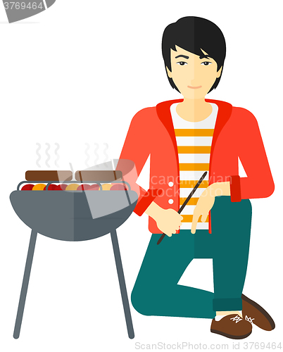 Image of Man preparing barbecue.