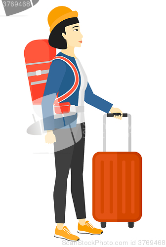 Image of Woman with bzckpack and briefcase.