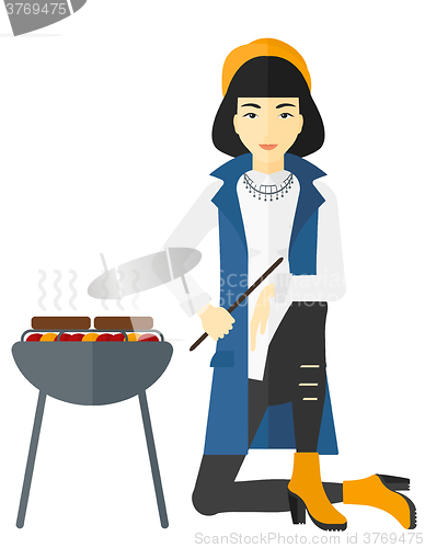 Image of Woman preparing barbecue.