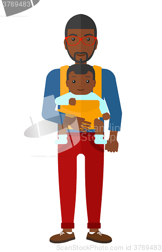 Image of Man holding baby in sling.