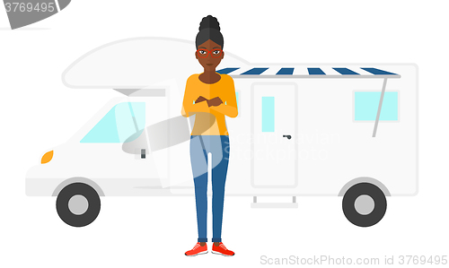 Image of Woman standing in front of motor home.