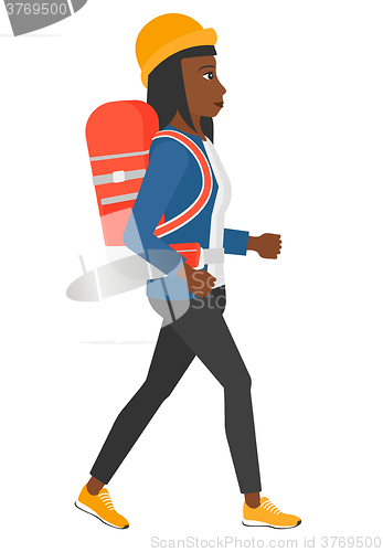 Image of Woman with backpack hiking.