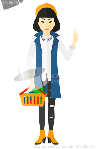 Image of Woman holding supermarket basket.