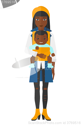 Image of Woman holding baby in sling.