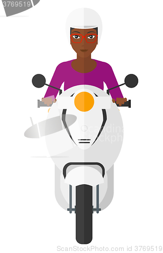 Image of Woman riding scooter.