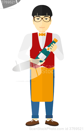 Image of Waiter holding bottle of wine.