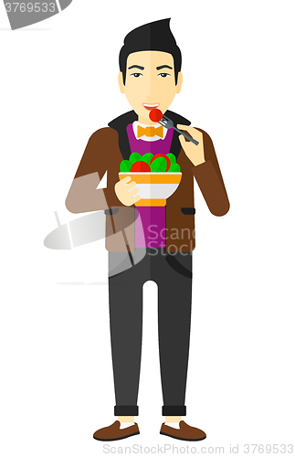 Image of Man eating salad.