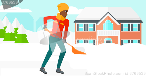 Image of Woman shoveling and removing snow.