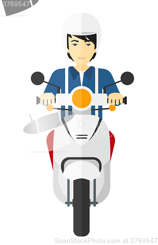 Image of Man riding scooter.