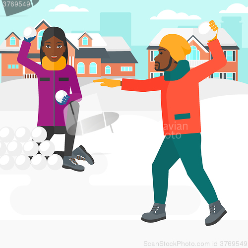 Image of Couple playing in snowballs.