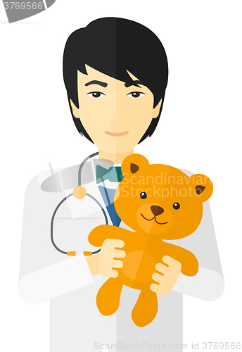 Image of Pediatrician holding teddy bear.