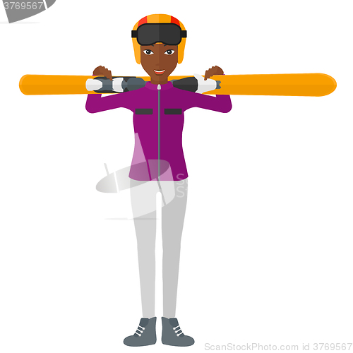 Image of Woman holding skis.