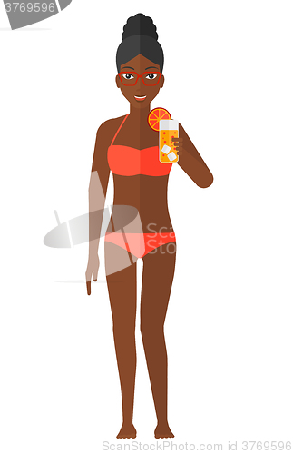 Image of Tourist holding cocktail.