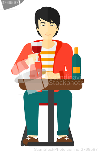 Image of Man sitting at bar.