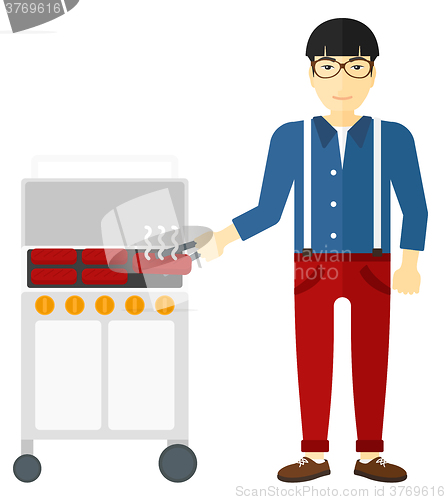 Image of Man preparing barbecue.