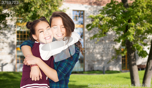 Image of happy smiling pretty teenage student girls hugging