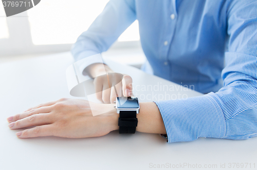 Image of close up of hands setting smart watch