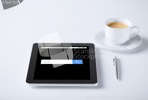 Image of tablet pc with internet browser search and coffee