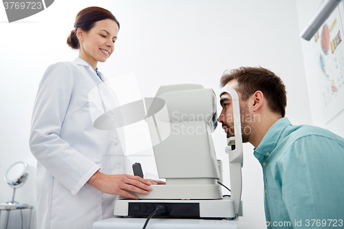 Image of optician with tonometer and patient at eye clinic