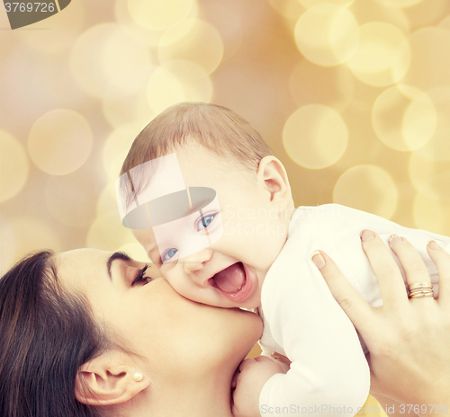 Image of laughing baby playing with mother