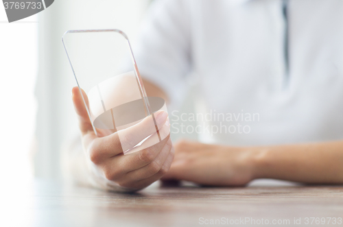 Image of close up of woman with transparent smartphone