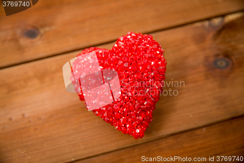 Image of close up of red heart decoration on wood