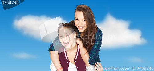 Image of happy smiling pretty teenage girls hugging