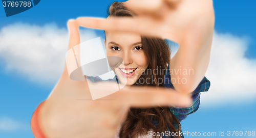 Image of happy teenage girl making frame of fingers