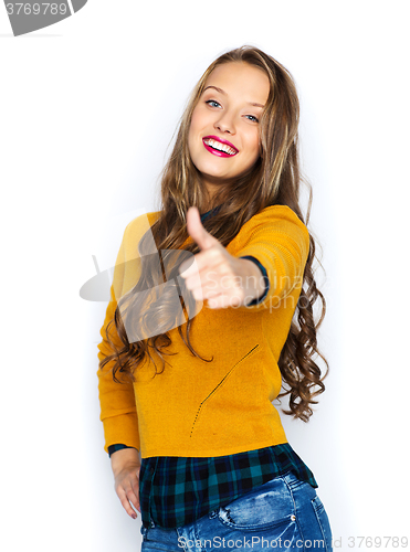 Image of happy young woman or teen girl showing thumbs up