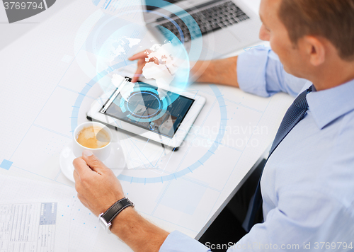 Image of businessman with tablet pc and coffee in office