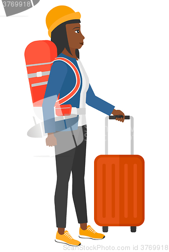 Image of Woman with bzckpack and briefcase.
