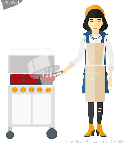 Image of Woman preparing barbecue.