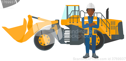 Image of Miner with mining equipment on background.