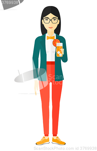 Image of Woman holding glass of juice.