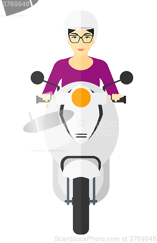 Image of Woman riding scooter.