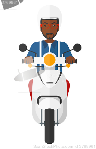 Image of Man riding scooter.