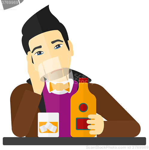 Image of Sad man with bottle and glass.