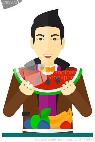Image of Man eating watermelon.