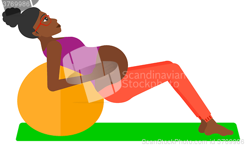 Image of Pregnant woman on gymnastic ball.