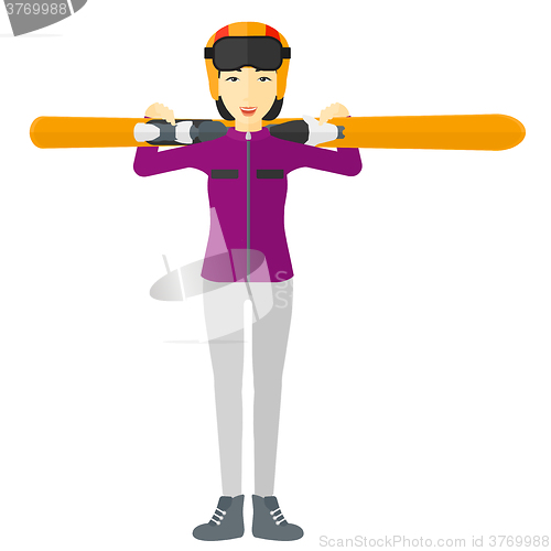 Image of Woman holding skis.