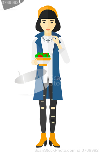 Image of Woman eating salad.