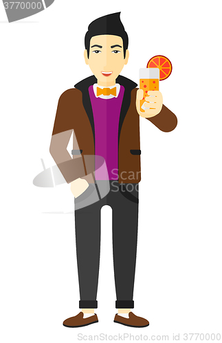 Image of Man holding glass of juice.