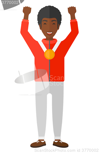 Image of Athlete with medal and hands raised.
