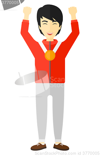 Image of Athlete with medal and hands raised.